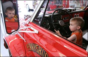 NBRS fire01p  06/27/2009     The Blade/Lori King  Perrysburg Township resident Cooper Bly, 2, plays with a fire truck during open house of the new Perrysburg Township Fire Dept. station in Perrysburg Township, OH.