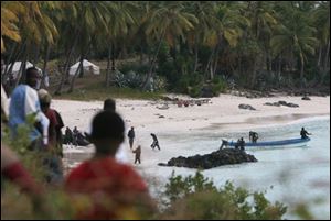 Rescuers gather at Galawa Beach, 35 kilometers from Moroni, Comoros, Wednesday, July 1, 2009, as they prepare to search the area. A teenage girl is the only known survivor of a Yemenia Airbus passenger plane which crashed into the Indian Ocean off the island nation of Comoros, early Tuesday, as it attempted to land in the dark amid howling winds. 