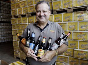 Brewmaster Jimmy Mauric shows off Shiner beer at Spoetzl Brewery in Shiner, Texas. The firm is celebrating its century mark.