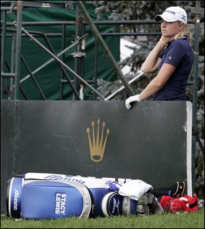 Stacy Lewis awaits a ruling after hitting her ball over the 18th green at the Jamie Farr Owens Corning Classic yesterday in Sylvania. The Toledo native missed the cut despite shooting 1-under par for two rounds.