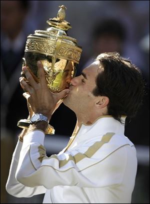 Roger Federer of Switzerland kisses the trophy after defeating Andy Roddick of U.S. in their men's final match on the Centre Court at Wimbledon, Sunday, July 5, 2009.
