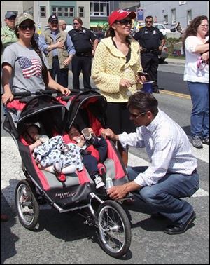 Sarah Palin along with daughter Bristol, left watch the Juneau Fourth of July parade, as husband Todd, looks over son Trig and grandson, Tripp, Bristol's son, Saturday, July 4, 2009 in Juneau, Alaska. 