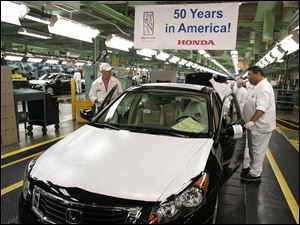 Workers at Honda's first U.S. auto plant in Marysville, Ohio, assemble vehicles on the 50th anniversary of American Honda Motor Co.'s June 11, 1959, start.
