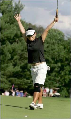 Eunjung Yi celebrates as her birdie putt on the first playoff hole falls into the hole to win the Jamie Farr Owens Corning Classic. It was the first victory on the LPGA Tour for the 21-year-old.