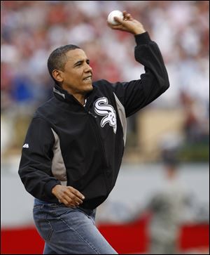 President Obama, sporting the colors of his hometown team, the Chicago White Sox, throws the ceremonial first pitch.