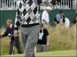 Tom Watson acknowledges the crowd after finishing with a 65 on day one of the British Open.