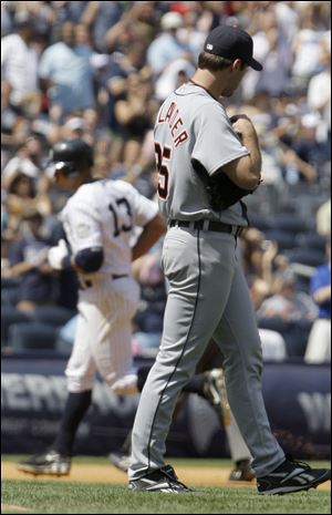 A disgusted Justin Verlander watches Alex Rodriguez round the bases after his seventh-inning home run. The ball barely cleared the right-field wall. 'I'd rather a guy hit it 10 miles,' said Verlander, who took a three-hit shutout into the inning but saw his record fall to 10-5.