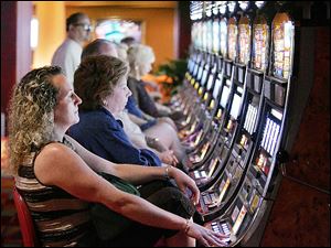 People play slot machines at Philadelphia Park Casino and Racetrack in this June 25, 2007 file photo.