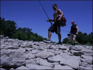 ROV drybed  07/14/2009     The Blade/Lori King  Eric Valentine, of Holland, left, and Perrysburg resident Andrew Zaletel walk on the dry stone bed of the Maumee River at SideCut Metropark in Maumee , OH. Little rain has fell this month, and river and creek beds are drying up as a result.