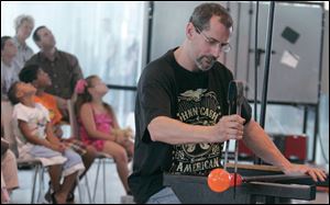 Steve Cothern, assistant studio manager at the Glass Pavilion, demonstrates the art of glass-blowing for visitors. Sunday's Glass Fest was part of a day of family activities at the museum. 