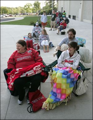 Melissa Mackey of Worthington, Ohio, left, and Michelle Sidner of Dublin, Ohio, camped out overnight, but lost their chance to be first in line. Tickets are on sale again Wednesday at UT.