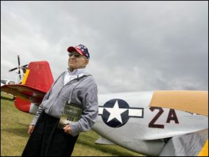 Art Jibilian of Fremont stands next to a P51 Mustang, the aircraft flown by the Tuskegee Airmen during World War II. Mr. Jibilian and the airmen were honored at AirVenture 2009 in Oshkosh, Wis.