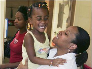 Ebonee Bush picks up Samyah Hawkins at preschool at the Y. Officials say the recent loss of state child-care funds is one reason for closing the branch.