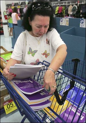 Toledoan Fay Bovee stocks up on notebooks priced at a nickel as she shops for school supplies for her grandchildren.