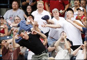 Some of the 6,379 fans at Fifth Third Field last night battle for a foul ball during the Hens  win. 
