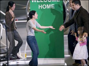 Journalists Laura Ling, left, and Euna Lee prepare to embrace their families upon arrival at an airport near Los Angeles. The two women had been detained in North Korea since March.