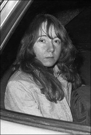 In this 1975 photo Lynette Fromme sits in a U.S. Marshal's auto in Sacramento, Calif.