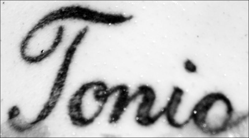 This tattoo of the name Tonio in cursive writing was found above 