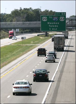 Vehicles travel on the Ohio Turnpike near Maumee yesterday. AAA predicts 39.1 million Americans will travel more than 50 miles from home this weekend. That would be 6 million fewer than last year, which was the busiest Labor Day for travel this decade.