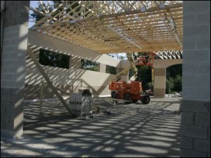 Workers from Willson Builders place roof trusses as part of the  expansion of the Lewis Avenue Fire Station. 