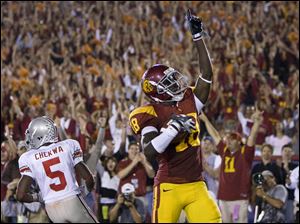 Damian Williams celebrates after catching a touchdown pass last year against the Buckeyes. Ohio State was crushed 35-3.