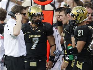 Colorado coach Dan Hawkins talks with quarterback Cody Hawkins, his son, duiring their game against Colorado State.