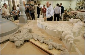 Seneca County officials and members of a redevelopment group get a look at ornate architectural items made from fiber glass.