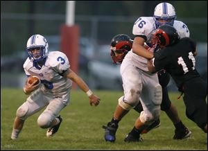 Anthony Wayne's Andrew Donnal (76), a 6-foot-7, 280-pound lineman, blocksBrandon Hunt of Rogers to clear the way for running back Matt Green.
