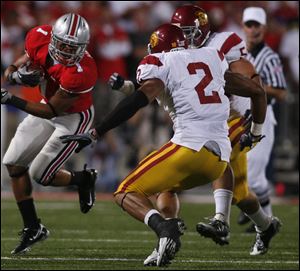 Ohio State's Dan Herron tries to get past USC's C.J. Gable in Saturday night's game in Columbus.