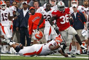 Ohio State linebacker Brian Rolle avoids Illinois' Jon Asamoah after an interception in the first half. OSU had consecutive shutouts for the first time since 1996.