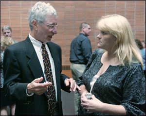 Lucas County Health Commissioner Dr. David Grossman talks to Clay High School parent Debbi Hornyak at the school in Oregon.