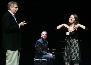 Composer and songwriter Marvin Hamlisch, left, critiques Elizabeth Romey, a junior at Springfield High School, one of three students who did an 'audition' at the Valentine Theatre tutorial session. Pianist Chris Henke, center, of Toledo, accompanied the young singers. Forty-eight students from throughout the area attended the tutorial.