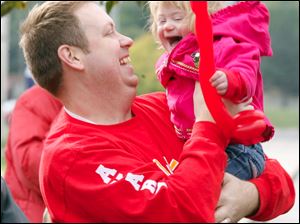 Slug:  CTY walk05p                      Date 10/4/2009           The Blade/ Amy E. Voigt                   Location: Toledo, Ohio  CAPTION:   Shane Long, from Toledo, holds his daughter Avary (cq) Long, 18 months, before the family walks in the Down Syndrome Association of Greater Toledo Buddy Walk in celebration of National Down Syndrome Awareness Month on October 4, 2009.