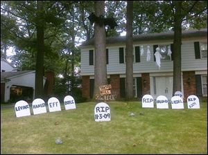 Royal Barber, a candidate for Sylvania Township trustee, displays the names of his opponents on his yard's Halloween display.