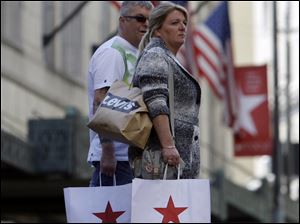 Shoppers pass a Macy's in Seattle. A late Labor Day and delayed school openings offered some relief to retailers n September.