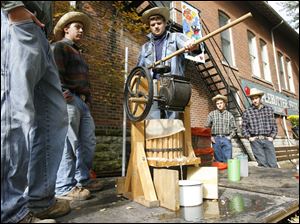 Slug: CTY festival12p                           Date 10/11/2009           The Blade/ Amy E. Voigt                   Location: Grand Rapids, Ohio  CAPTION: From left: Tom Wilson, Ryan Johnson, Jay Gallagher, Josh Main, and Ben Feather, use an apple press to make cider during the annual Apple Butter Festival in downtown Grand Rapids, Ohio. on October 11, 2009.