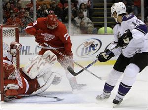Detroit goalie Chris Osgood stops a shot from Los Angeles' Justin Williams. Osgood had 24 saves in the win.