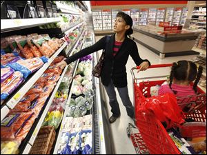 Kolleen Irwin shops for groceries with her daughter Ariel in Philadelphia. Low prices reflect stability for an economic recovery.