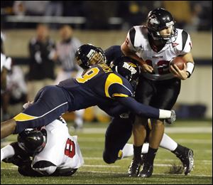 Toledo's Barry Church, left, and Archie Donald tackles Northern Illinois' Me'co Brown.