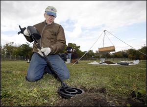 Volunteer Dan Drzewiecki surveys a section of soil during the archaeological dig to find artifacts. The battle was a catastrophic defeat for American forces during the War of 1812.