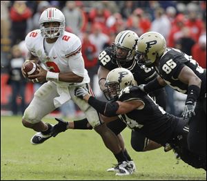 Ohio State quarterback Terrelle Pryor (2) is sacked by Purdue defensive end Ryan Kerrigan (94) and Keyon Brown (95) in the fourth quarter. The Boilermaker defense frustrated Pryor all day.