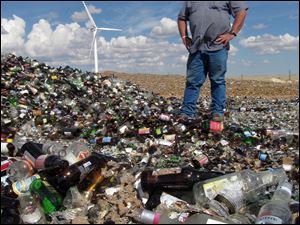 Monty Landers, landfill foreman in Cheyenne, Wyo., looks over a mountain of glass bottles. The landfill has been receiving 9 tons of glass a week, but hasn't found a taker to recycle it in years.
