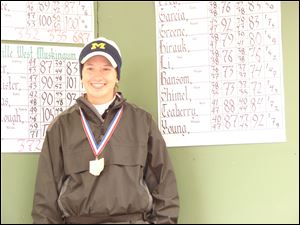 Eastwood's Alyssa Shimel collects her state championship medal after shooting a 73-72-145 at Ohio State's Gray Course.