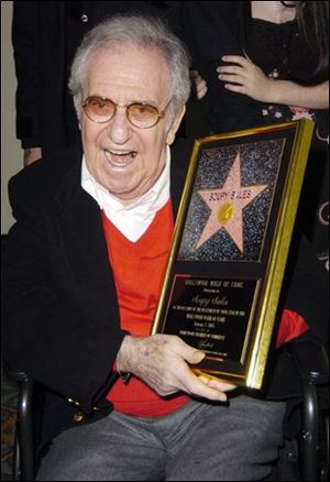 Soupy Sales poses for photographers with a replica, during a ceremony honoring him with a Star on the Hollywood Walk of Fame, in this January 7, 2005 file photo taken in Los Angeles. Sales, the rubber-faced comedian whose anything-for-a-chuckle career was built on 20,000 pies to the face and 5,000 live TV appearances across a half-century of laughs, died Thursday. 