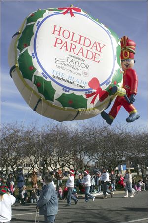 Taylor Automotive Group's helium-filled balloon makes its way along downtown Toledo streets during the 2008 parade.