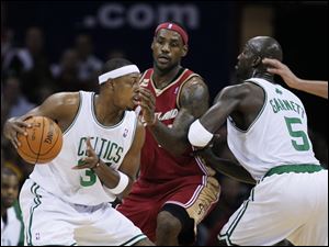 Boston's Paul Pierce, left, runs LeBron James into a screen set by Kevin Garnett. Pierce had 23 points, and Garnett tallied 13.