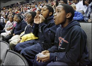 Omar Johnson, Marquis Brent, and Marnakio Tyler, from left, all fifth graders at Lagrange Elementary, watch the Walleye.