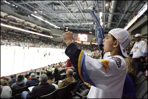 Jawad Mahmoud, a seventh grader at Arbor Hills Junior High, cheers for the Toledo Walleye at the Lucas County Arena yesterday. It was the first hockey game Jawad had ever attended.