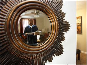 Slug:CTY tour08p                         Date 11/7/2009           The Blade/ Amy E. Voigt                   Location: Toledo, Ohio  CAPTION:  Johnny Reese Sr. looks at the guide to see which home he will hit next while being reflected in a mirror at 174 Kingswood Trail during the Tour Toledo Preview of Homes tour that was open to the public on November 7, 2009.