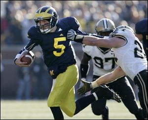 Michigan quarterback Tate Forcier breaks free of Purdue's Jason Werner in the fourth quarter. Forcier was sacked four times.
<br>
<img src=http://www.toledoblade.com/graphics/icons/photo.gif> <font color=red><b>VIEW</b></font>: <a href=